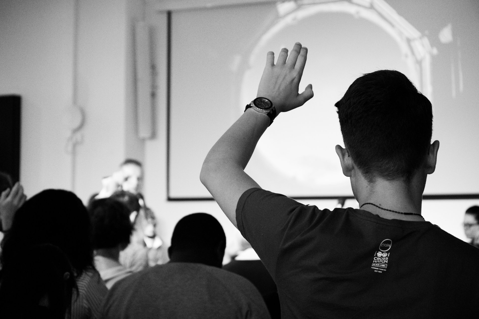 High school student raising their hand in class