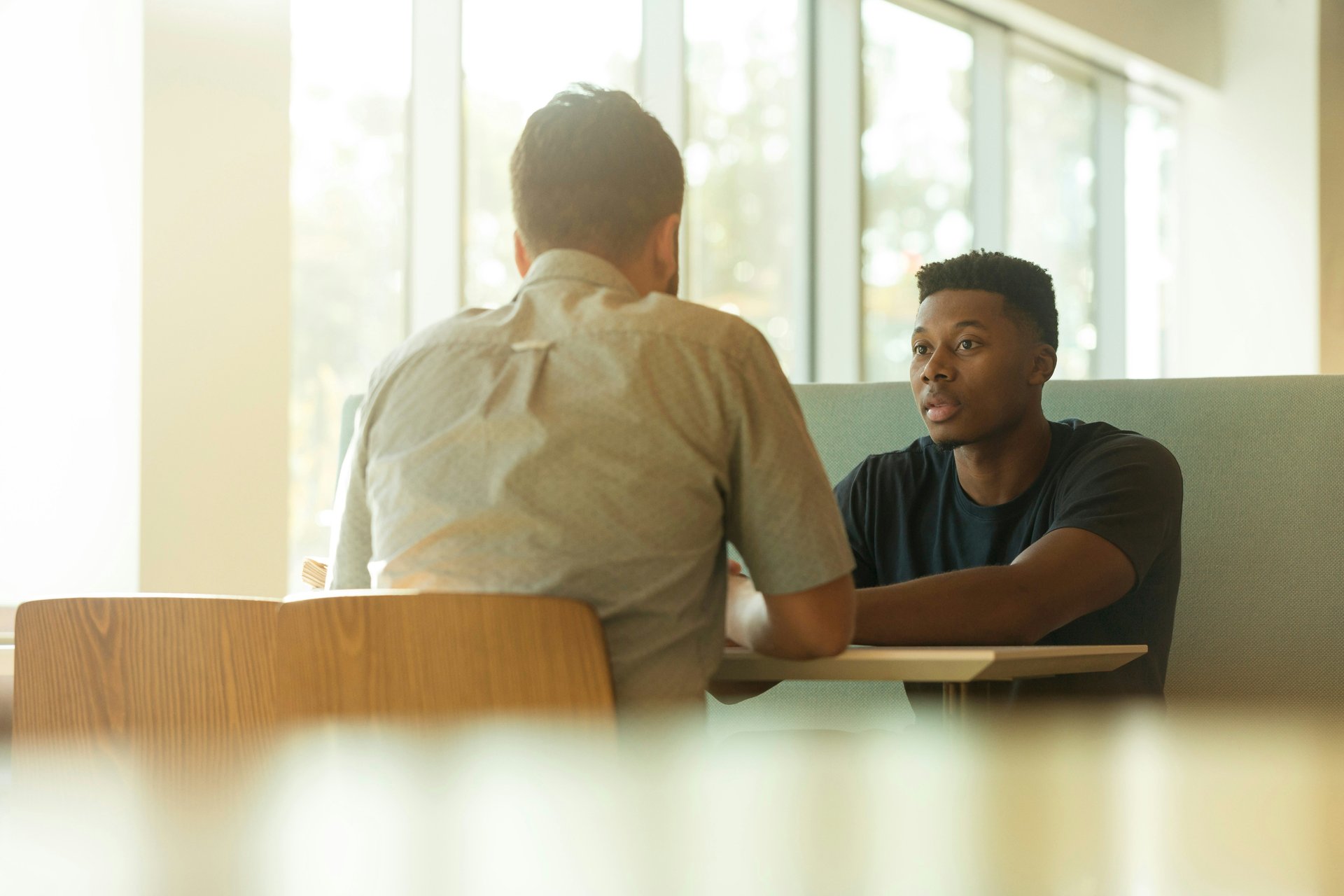 Teacher and student in a serious one-on-one meeting
